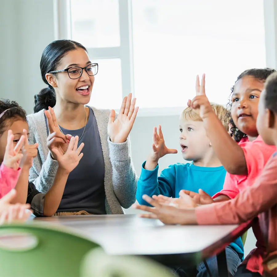 Kids And Teacher At Table