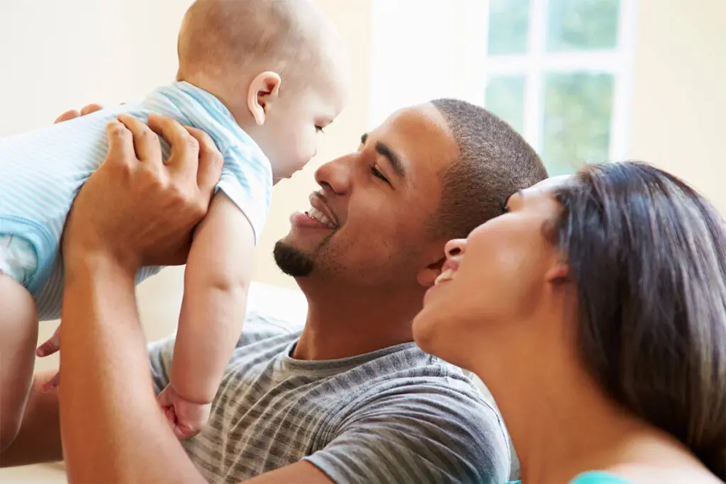 Adults Holding A Baby