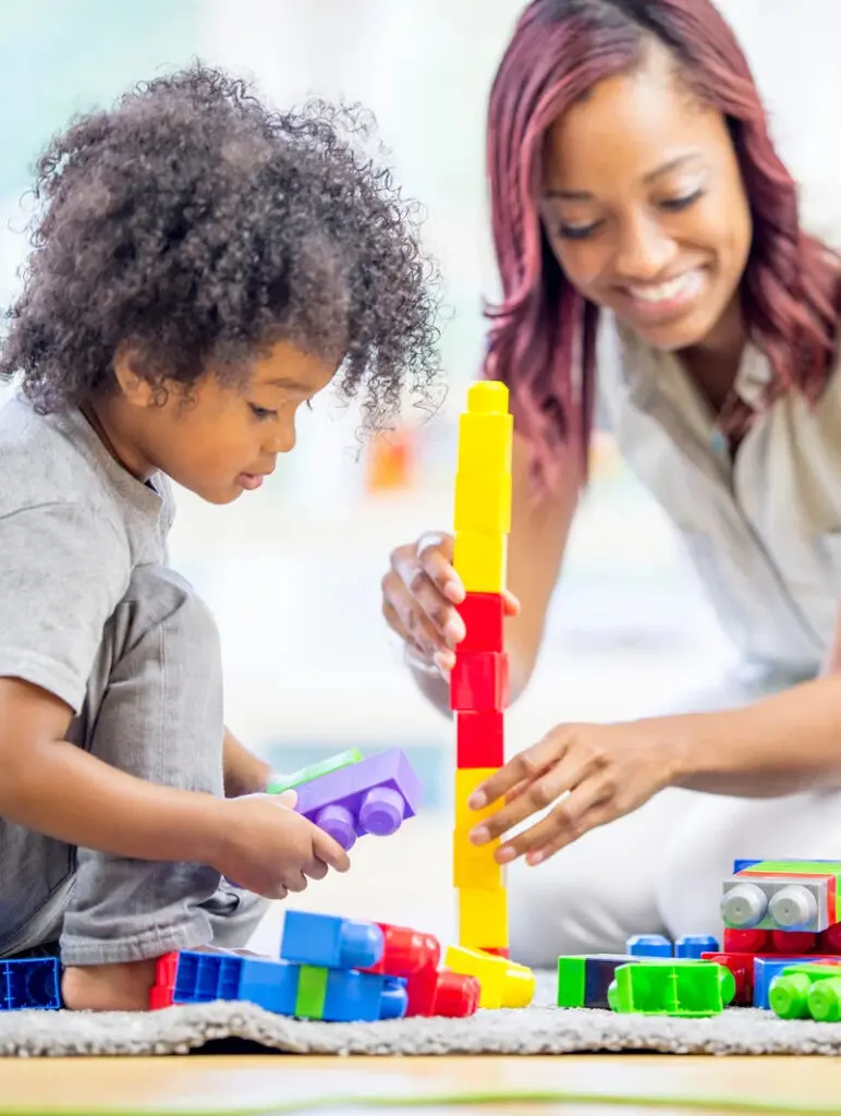 Adult And Child Playing With Plastic Blocks