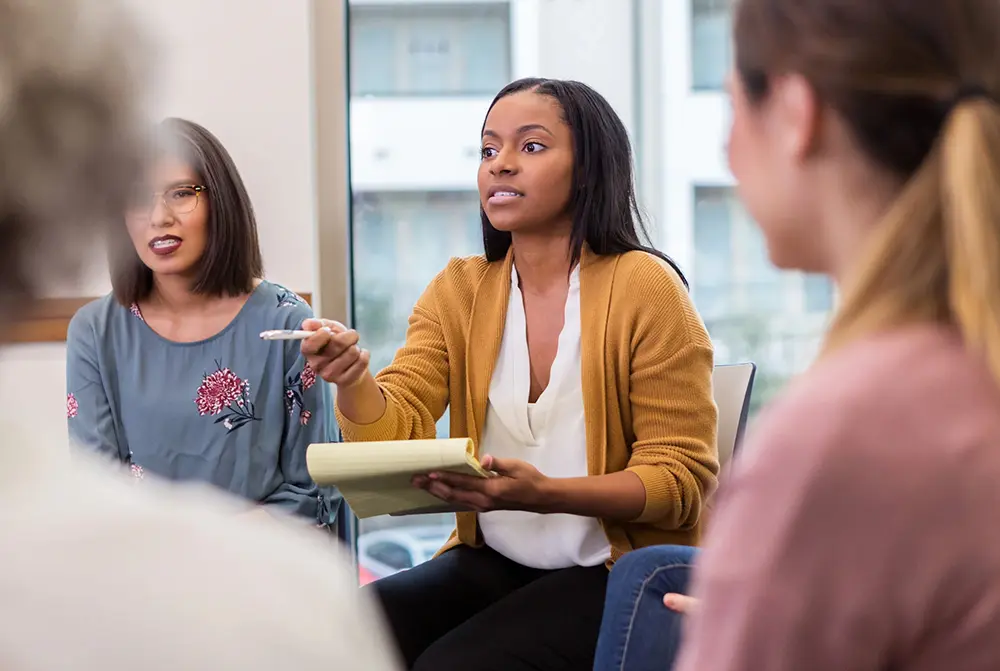 Four Adults In Training Meeting